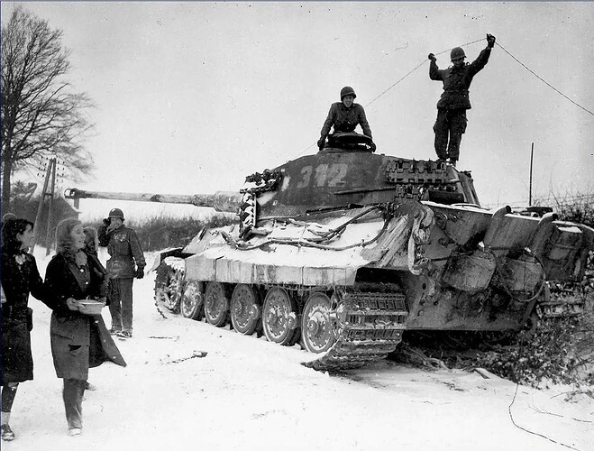 Two+American+soldiers+inspect+a+destroyed+German+King+Tiger+tank,+Belgium,+1944.jpg